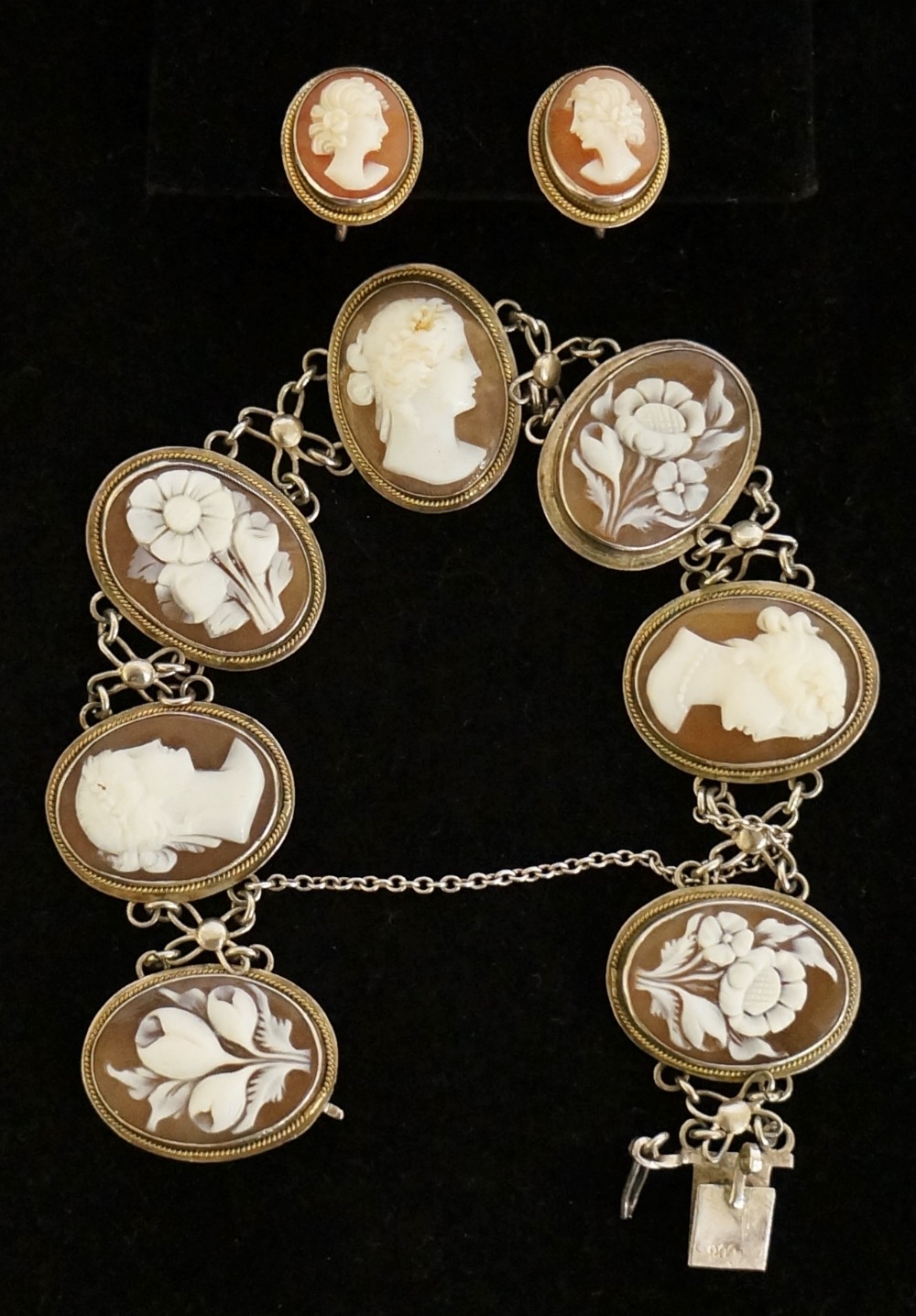 An 800 standard cameo bracelet alternately set with oval panels carved with female heads and