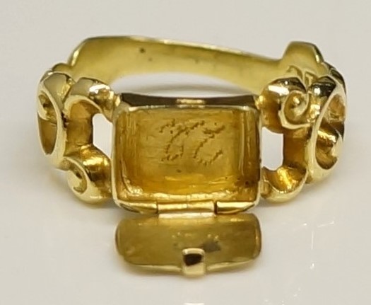 A Victorian gold pill box ring with central hinged "satchel", pierced S-scroll leafy shoulders, - Image 2 of 2