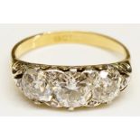 An 18 carat yellow gold three stone diamond ring, claw set circular brilliants,