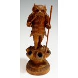 A spill holder carved as a dog, smoking a pipe, a sack on its back with staff in its left hand,