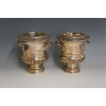 A pair of George III style silver plated wine coolers the urnular bodies with beaded rims above a