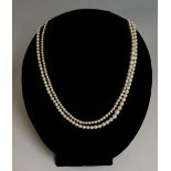 A double row cultured pearl necklace with diamond clasp, one row 37cm drop, the other 28cm drop,