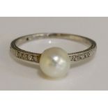 A natural salt water pearl and diamond ring, the shoulders set eight small brilliants, ring size N,