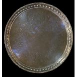 A Victorian circular salver with beaded rim, bell flower border,