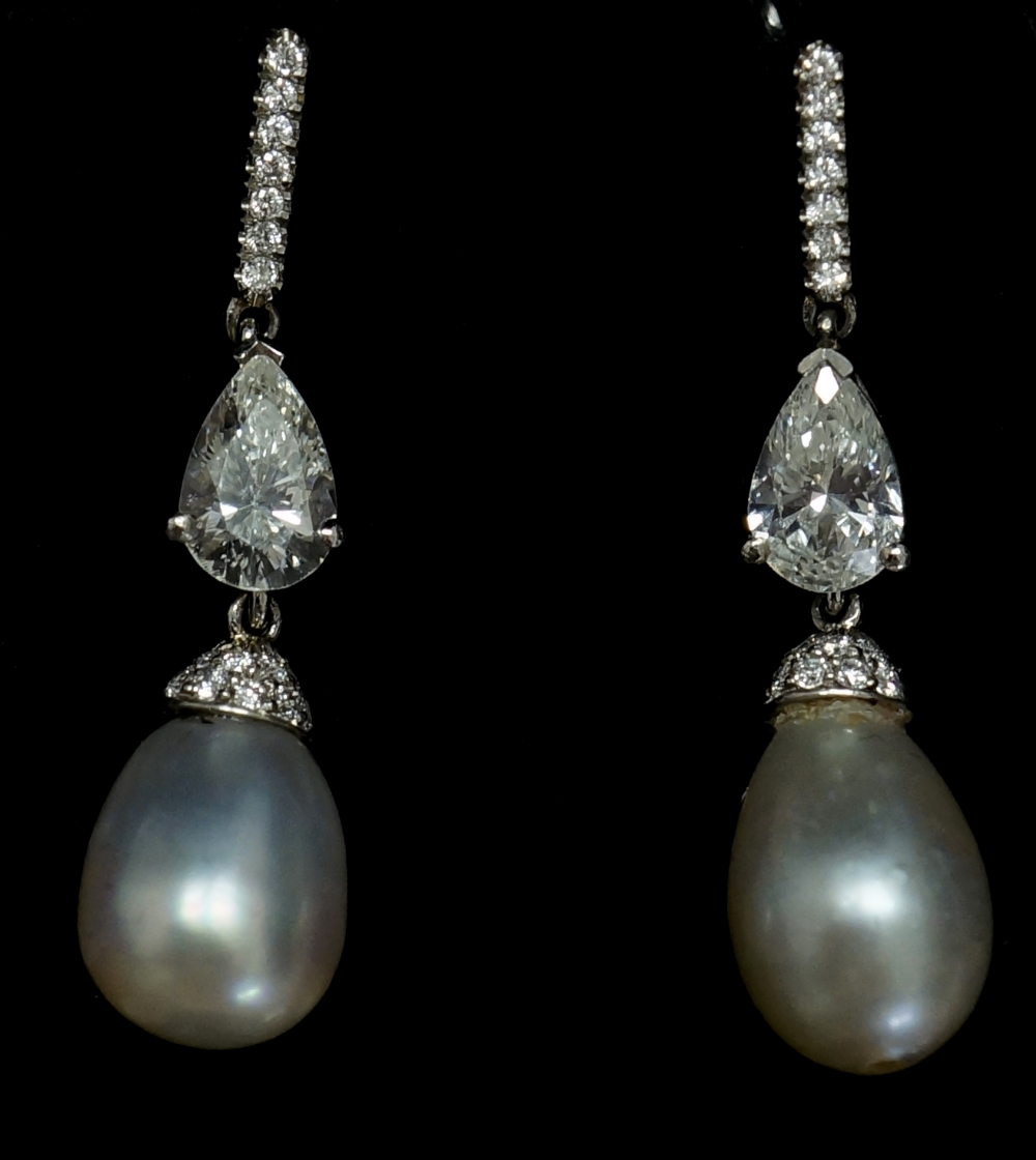 A pair of natural salt water pearl and diamond earrings the pearls with diamond collars beneath