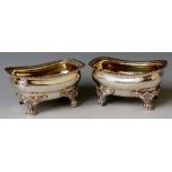 A pair of George IV salts of rounded rectangular design the ogee bodies with gadrooned rims on four