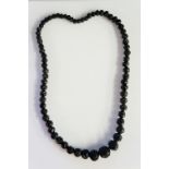 A Whitby Jet necklace of carved graduated design, smallest bead approx. 0.