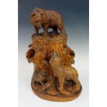 A lidded box finely carved as a bear atop a rustic stump with two smaller bears beneath, 38cm high,