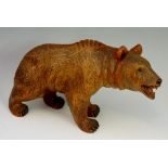 A well carved bear with glass eyes and open mouth, 24.