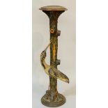 A 19th Century carved and painted torchère modelled with a crane and tree trunk, glass eyes,