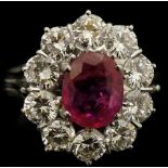A Burmese ruby and diamond ring, the oval ruby claw set,