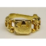 A Victorian gold pill box ring with central hinged "satchel", pierced S-scroll leafy shoulders,