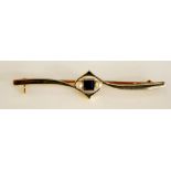 An Edwardian 18ct white and rose gold bar brooch of pierced interlaced design centred on a square