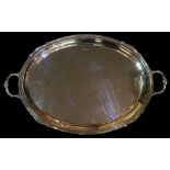 An oval two handled tray with moulded rim, pair of foliate clasped handles,