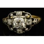A late 18th / early 19th Century diamond ring with central cushion cut brilliant flanked by four