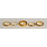 A 22ct gold wedding band, 8gms, a foliate engraved 18ct gold wedding band, 3gms,