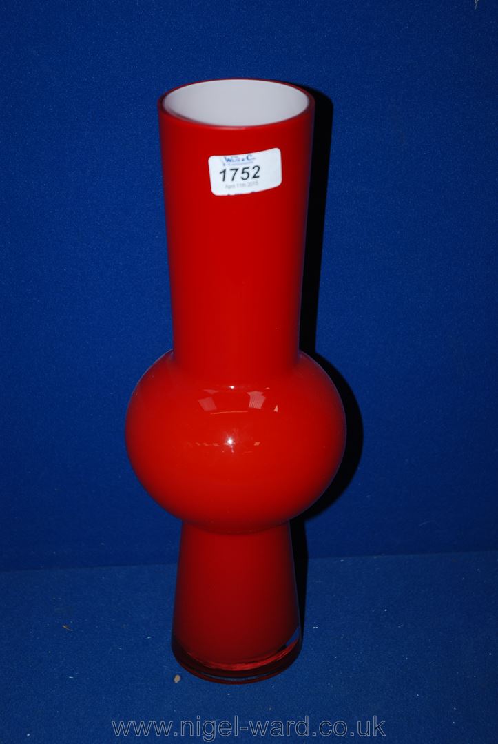 A 1970's Danish 'Holmegaard' red cased glass Vase with bulbous waist and lined in white glass, on