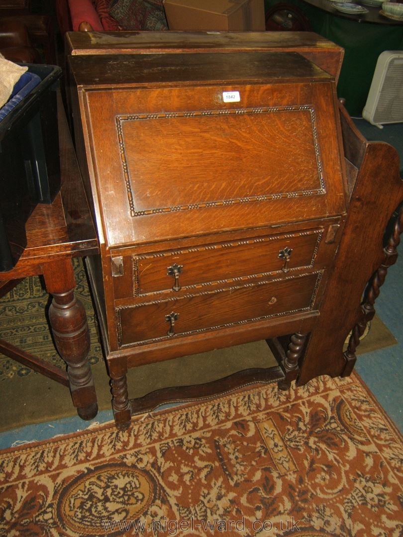 A 1940's Oak Bureau, having moulded fall, automatic lopers, frieze drawers and long lower drawer,