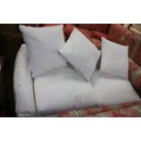 A small two seater single arm Sofa in white shadow pattern fabric