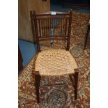 An arts and crafts Mahogany hall Chair, slender back rails with delicate spindle back, woven rush