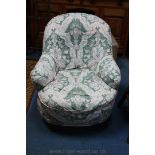 A Victorian tub style Nursing Chair, hoop back, in loose floral cover,