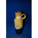 A 1970's West German Pot with round handle in mustard and brown glaze with central style surround,