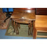 A reproduction nest of three Walnut Tables, quarter veneered tops with moulded edges, standing on