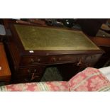 A reproduction Georgian style Kneehole Desk, having green leather inset top with moulded edge,