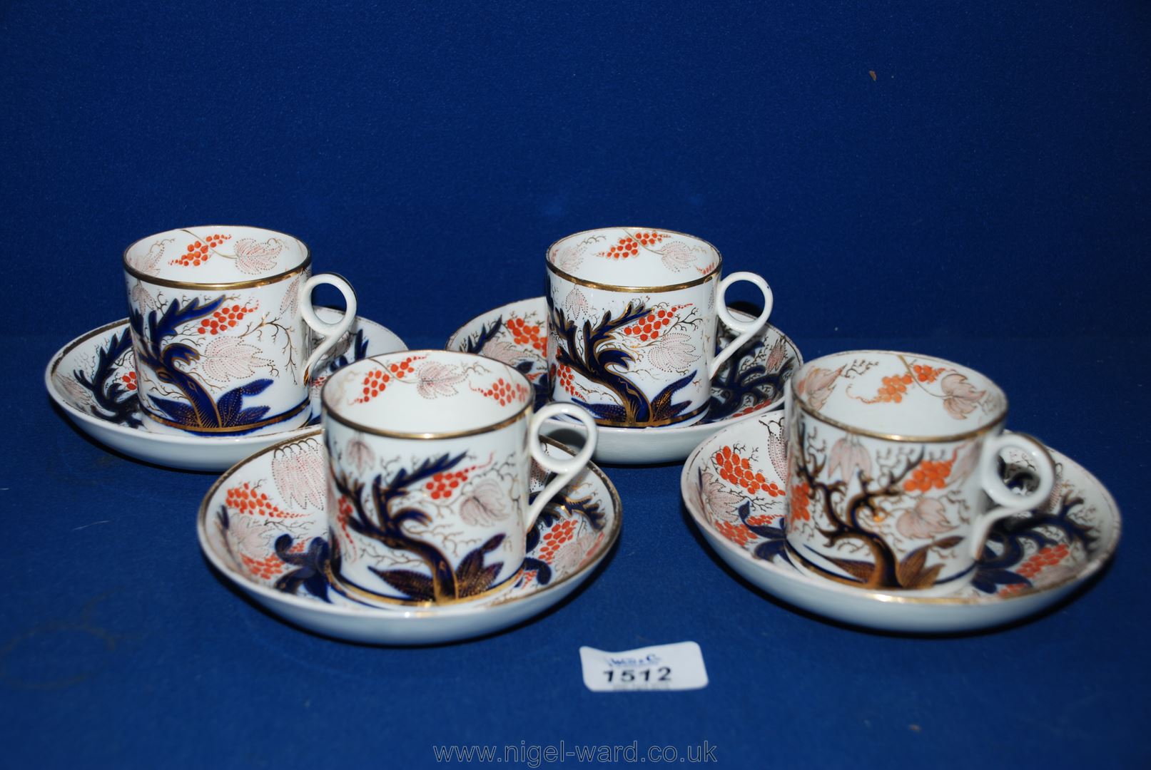 Four Coalport Coffee Cans and saucers, white ground with blue, orange and gilt decoration.