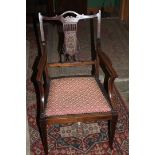 An elegant Edwardian Mahogany salon Elbow Chair, having pierced and fret cut inlaid splat back,