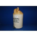 A large stoneware advertising Bottle with original top and tap ''J. Abercrombie Grocer, High Town,