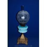 A Victorian cast iron Oil Lamp with turquoise glass reservoir and shade