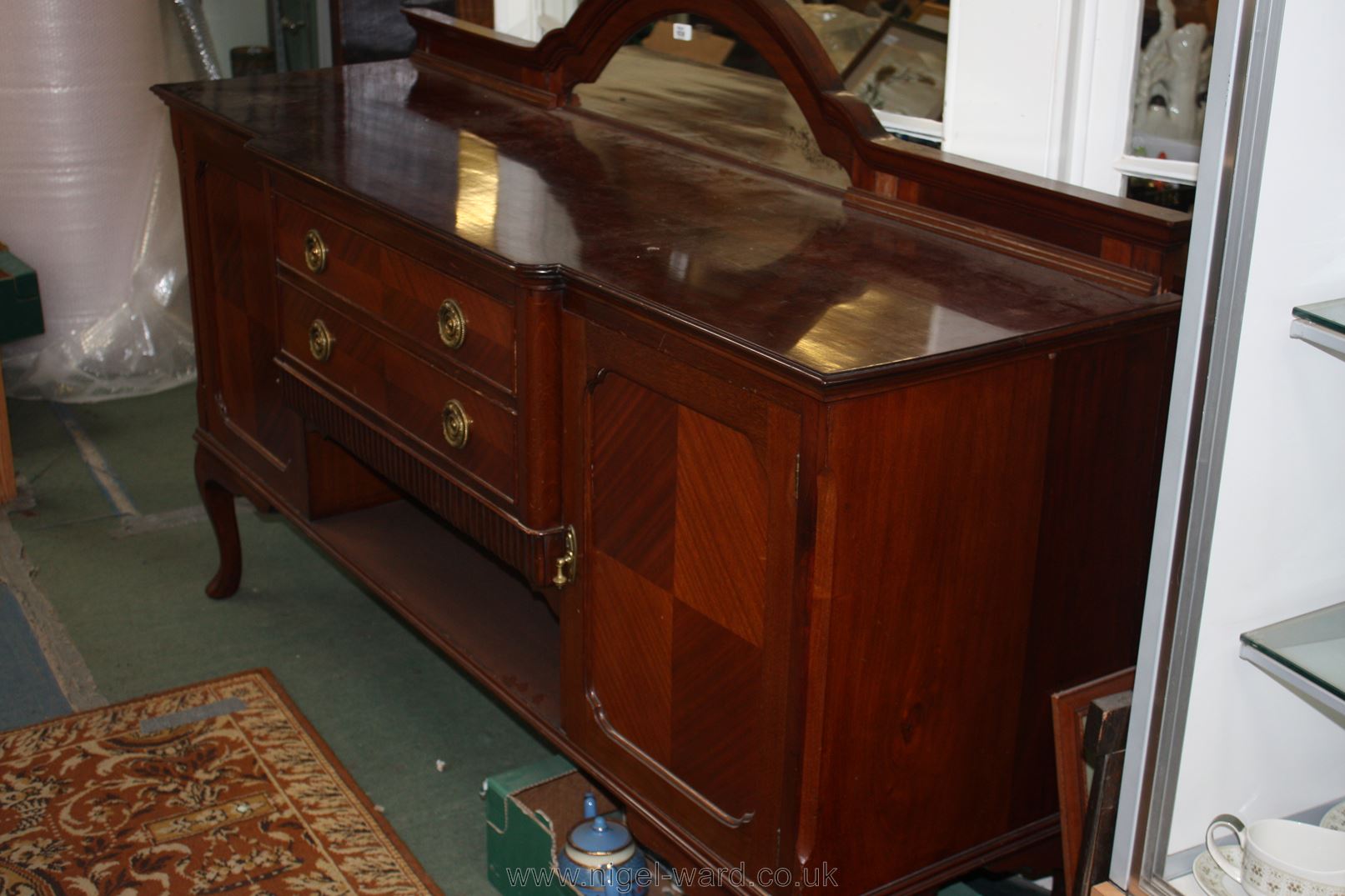 A late Victorian Mahogany Sideboard with dome top upstand having moulded edges and 'D' shaped