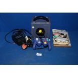 A Nintendo Game Cube vide games Console with Legend of Zelda game and controller.