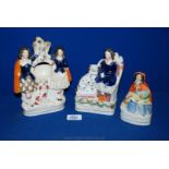 Three Staffordshire flatback figures including clock stand, and two of Ladies with their dogs