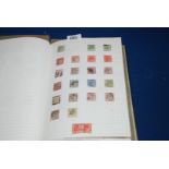 A blue Stamp Album containing British Empire and Commonwealth mix, notably Tonga, Transvaal,