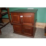 A small reproduction table-top Oak four door Cabinet, the two plank top having moulded edges,