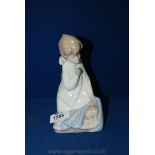 A Lladro figure of an angel with baby, a/f - (finger tip missing)