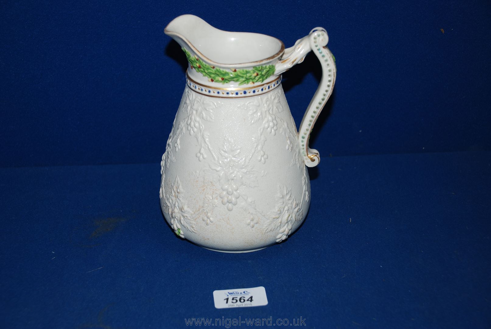 An early Victorian white stoneware Jug, moulded in low relief with vine decoration, coloured hop