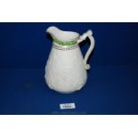 An early Victorian white stoneware Jug, moulded in low relief with vine decoration, coloured hop