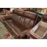 A modern brown leather three seater Sofa with padded arms and reclining back