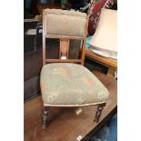 An Edwardian Mahogany frame Nursing Chair, padded back with urn inlaid short splat, olive green