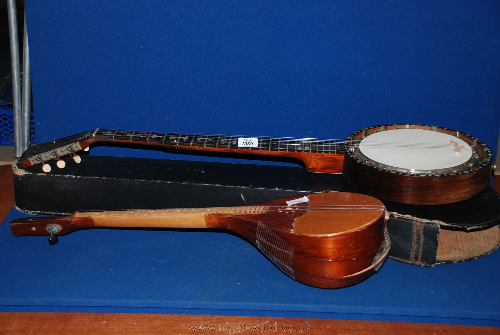 An old Banjo with mother of pearl inlay, cased; along with a wooden lute, a/f