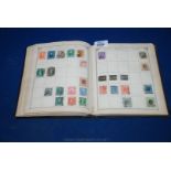 A Lincoln Stamp Album (dated 1902 on inside cover) containing a broad world mix, QV - GV,  many of
