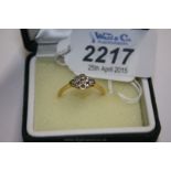 An 18ct Gold, Platinum set Diamond Ring with nine stones in diamond shape