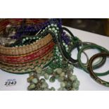 A basket of Costume jewellery including Bangles, polished Beads, etc.