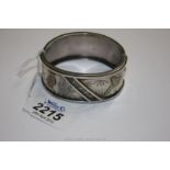 A wide Silver Bangle decorated in oriental style with birds and foliage, marked 'standard'