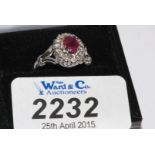 An 18ct. Gold oval Ruby and Diamond cluster RIng, hallmarked, with valuation and weight available.