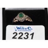 A 9ct. yellow gold Emerald & Diamond cluster RIng, hallmarked, with valuation certificate
