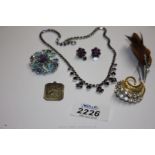 A small quantity of costume jewellery including Brooches, Earrings, Silver St. Christopher, etc.